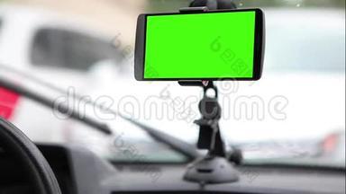 智能<strong>手机</strong>，在汽车仪表板的<strong>支架</strong>上有一个绿色屏幕。